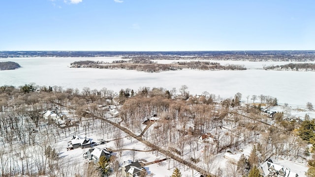 snowy aerial view featuring a water view