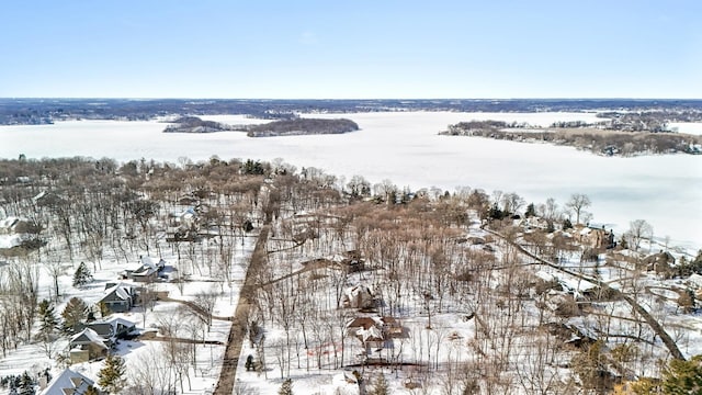 snowy aerial view with a water view