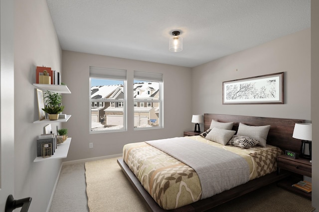 bedroom with baseboards and carpet