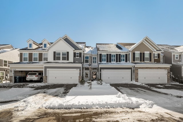 multi unit property featuring stone siding and an attached garage