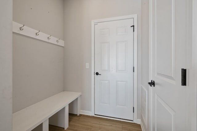 mudroom with wood finished floors and baseboards