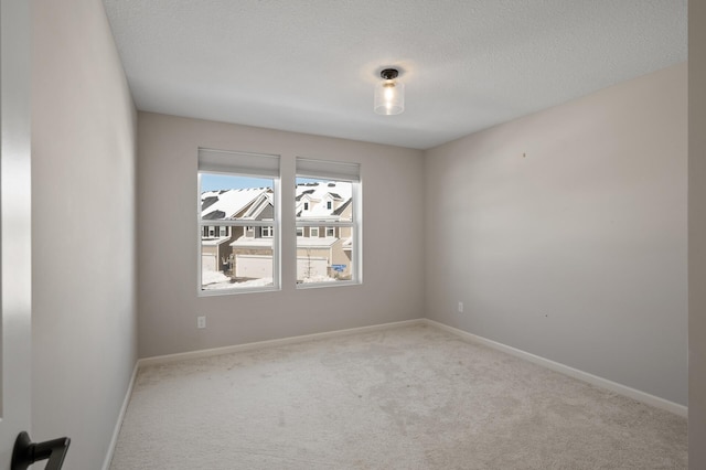 unfurnished room with baseboards, carpet floors, and a textured ceiling