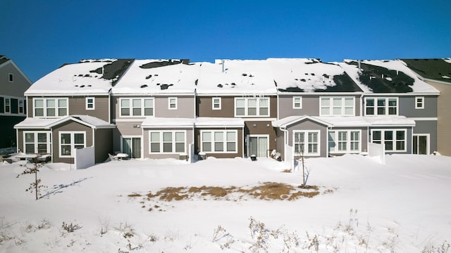 snow covered property featuring a residential view