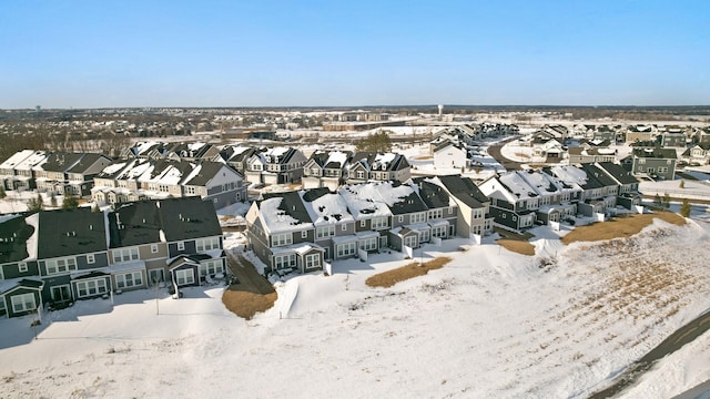 snowy aerial view featuring a residential view