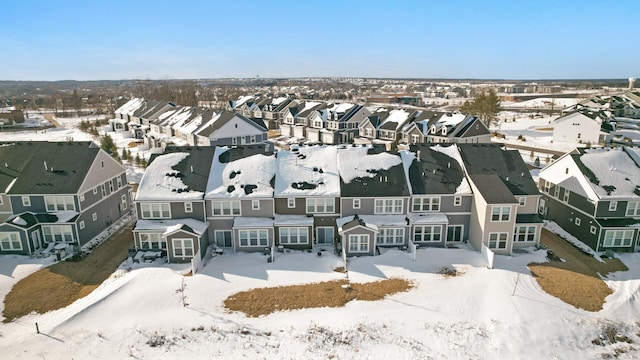 snowy aerial view featuring a residential view