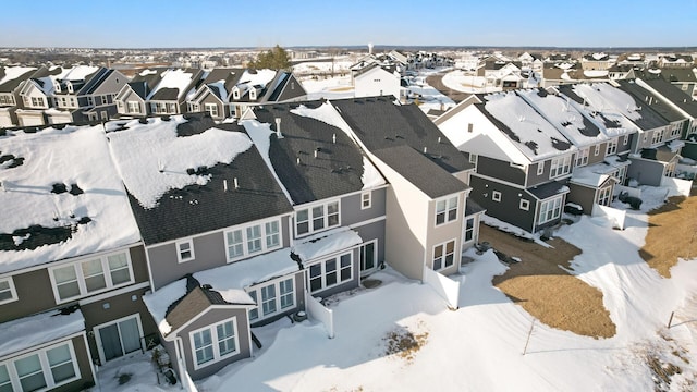 snowy aerial view featuring a residential view