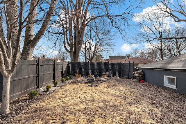 view of yard with an outdoor fire pit and a fenced backyard