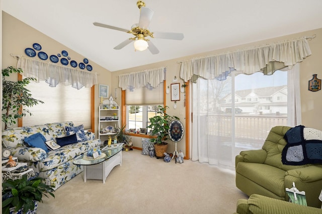 carpeted living area featuring ceiling fan and lofted ceiling