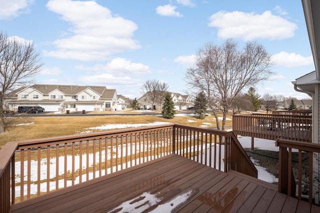 wooden terrace featuring a lawn and a residential view