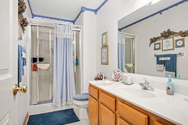 bathroom with tile patterned floors, toilet, a textured ceiling, a shower stall, and vanity