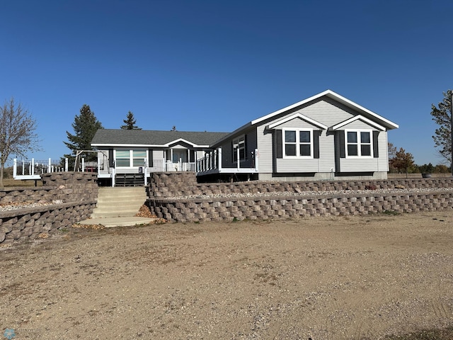 back of property featuring a deck and stairs