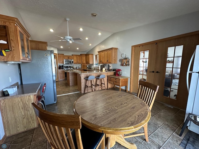 dining area featuring a ceiling fan, recessed lighting, french doors, and vaulted ceiling