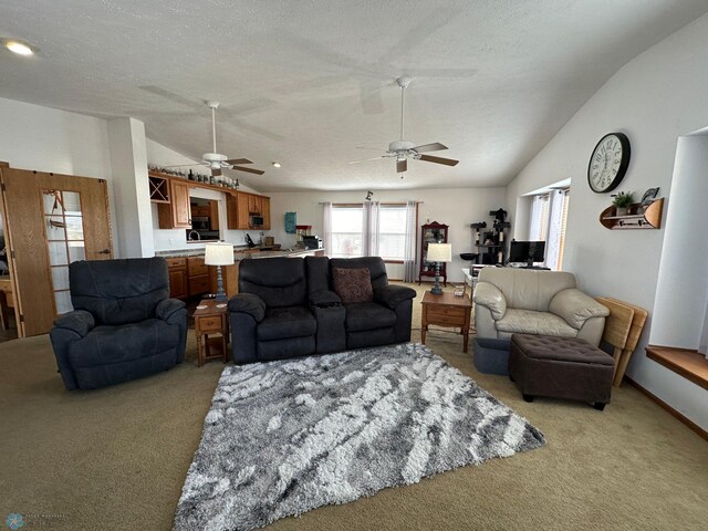 living room with a ceiling fan, light carpet, vaulted ceiling, and a textured ceiling