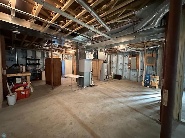 unfinished basement featuring heating unit, electric panel, and water heater