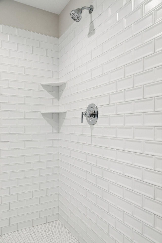 bathroom with a tile shower