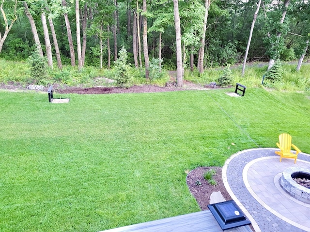 view of yard with a fire pit