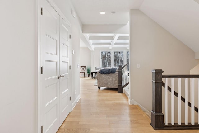 hallway featuring baseboards, beam ceiling, recessed lighting, light wood-style flooring, and coffered ceiling