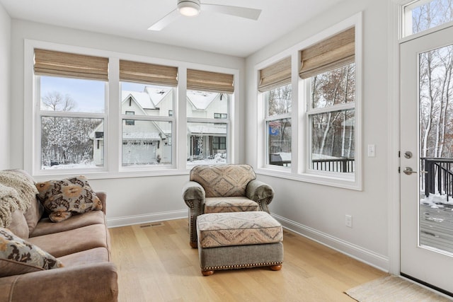 sunroom / solarium with visible vents and a ceiling fan