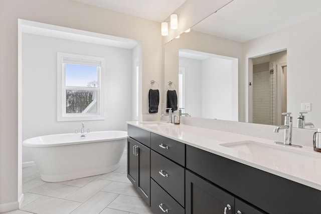 bathroom with double vanity, a soaking tub, a shower stall, and a sink