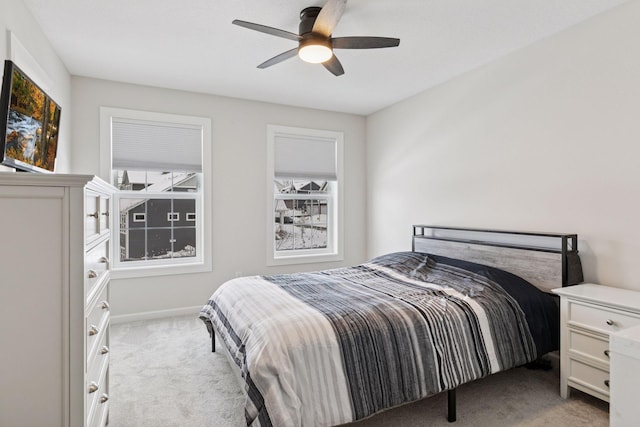 bedroom with light carpet and a ceiling fan