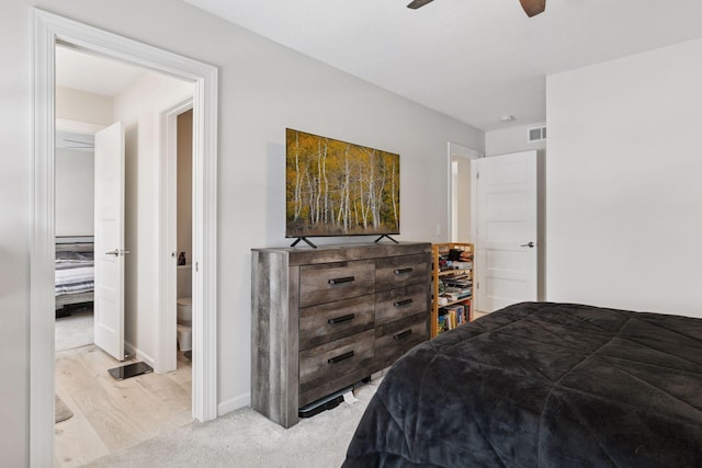 bedroom featuring visible vents, baseboards, light wood-style floors, and ceiling fan