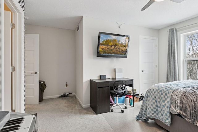 bedroom featuring baseboards, carpet floors, a textured ceiling, and ceiling fan