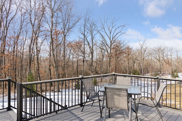 wooden terrace with outdoor dining space