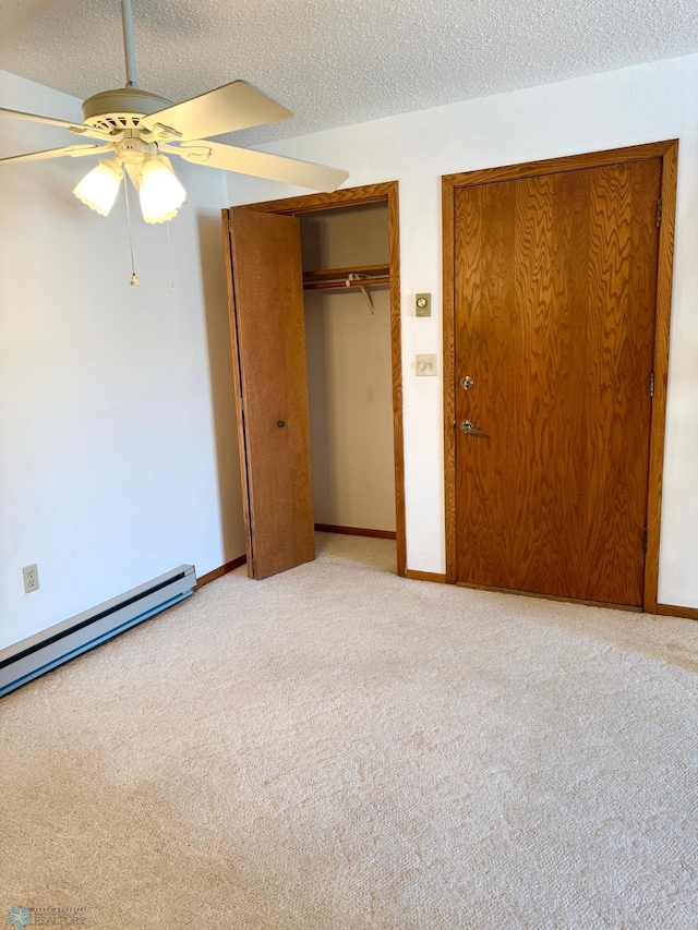 unfurnished bedroom with carpet, baseboards, and a textured ceiling