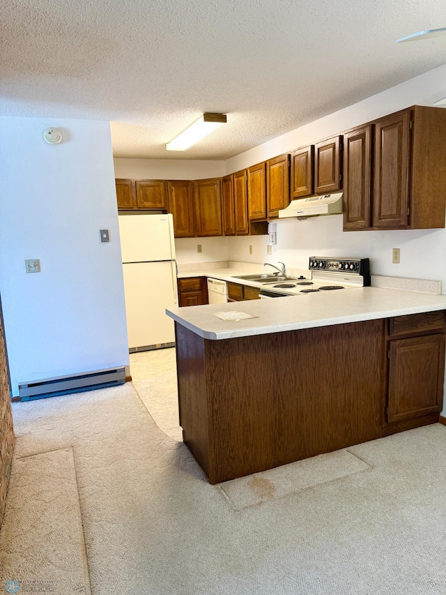 kitchen featuring white appliances, light countertops, under cabinet range hood, and a peninsula