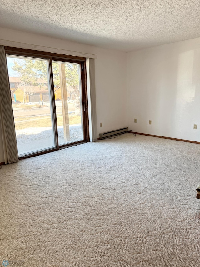 carpeted empty room featuring baseboards, a textured ceiling, and baseboard heating