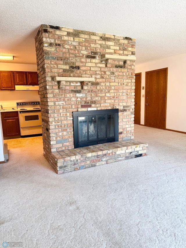 interior details featuring a fireplace, white electric stove, carpet flooring, a textured ceiling, and under cabinet range hood