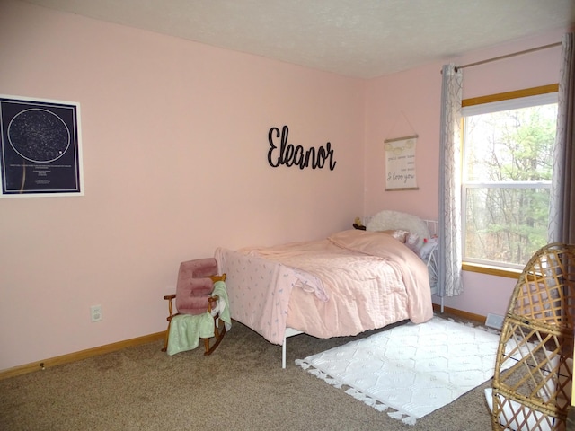 carpeted bedroom featuring baseboards