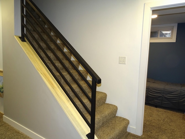 stairs featuring carpet flooring and baseboards