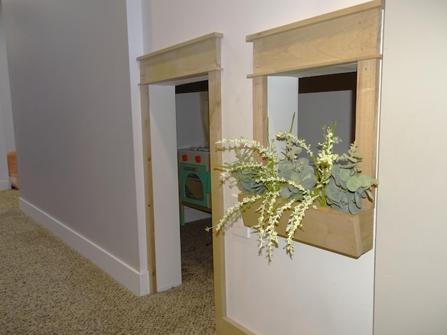 hall with carpet and baseboards