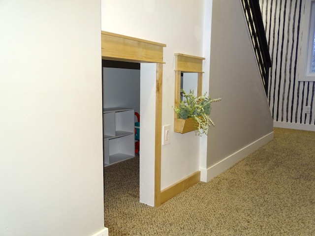 hall featuring carpet floors and baseboards