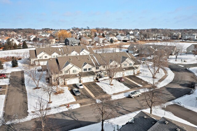 snowy aerial view featuring a residential view