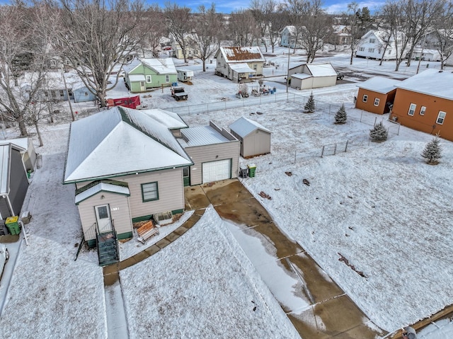 snowy aerial view featuring a residential view