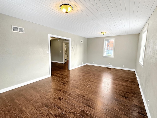 312 4th St E, Jasper, MN 56144 - empty room with dark wood-style floors, wooden ceiling, and baseboards