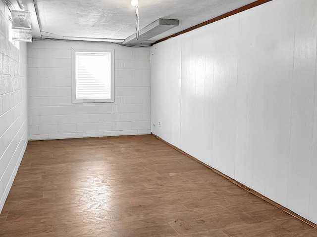 312 4th St E, Jasper, MN 56144 - unfurnished room with wood finished floors and concrete block wall