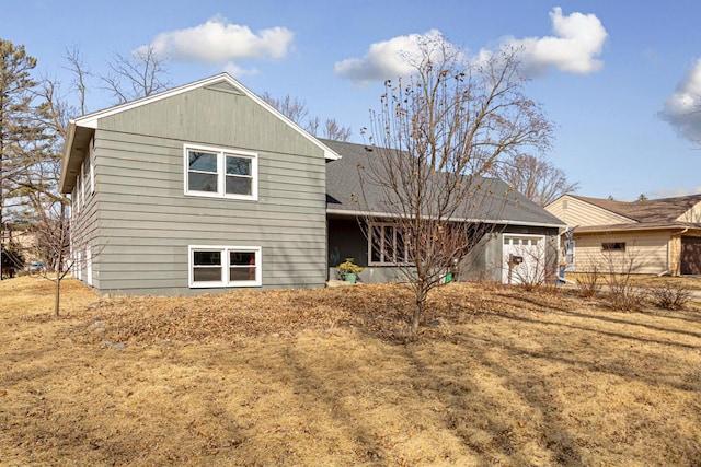 back of house featuring an attached garage