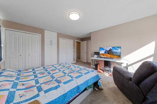 carpeted bedroom with multiple closets