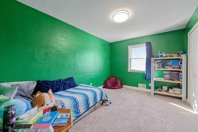 carpeted bedroom with baseboards and visible vents