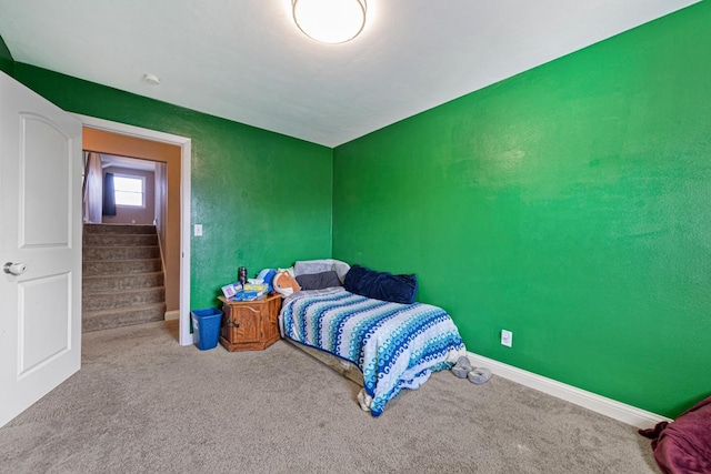 bedroom with carpet and baseboards