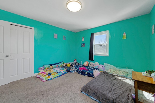 bedroom featuring a closet and carpet flooring