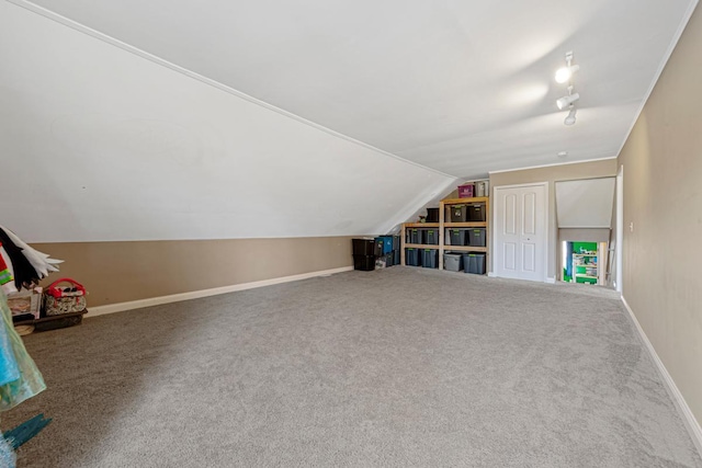 bonus room with lofted ceiling, carpet, and baseboards