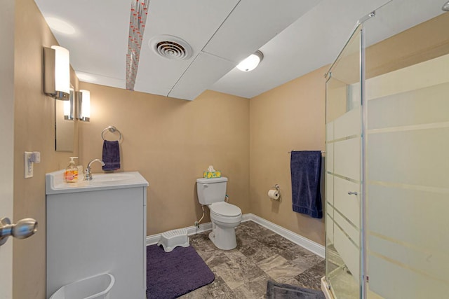 bathroom featuring visible vents, toilet, a shower stall, vanity, and baseboards