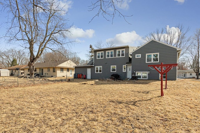 rear view of property with fence