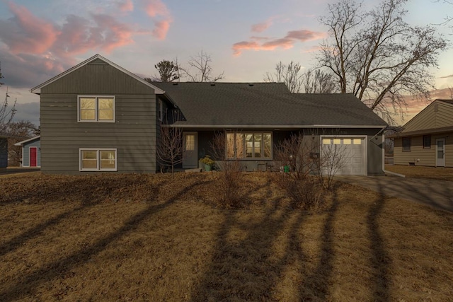 split level home featuring a garage and driveway