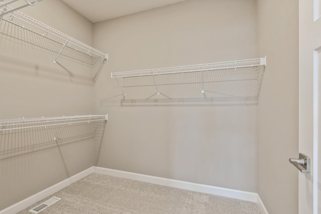 walk in closet with visible vents and carpet floors