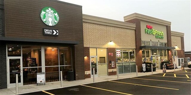 view of building exterior featuring uncovered parking